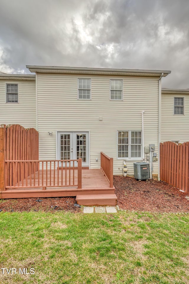 back of house featuring a lawn, central AC, a deck, and french doors