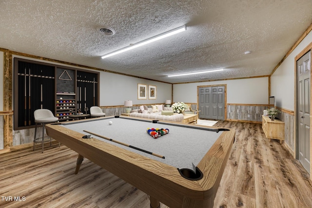 game room featuring crown molding, wood-type flooring, pool table, and a textured ceiling