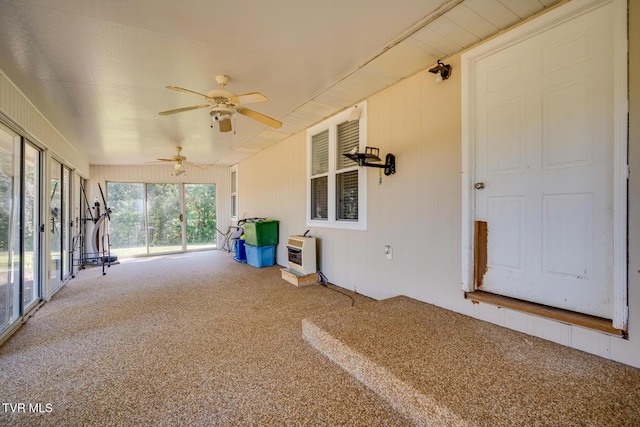 unfurnished sunroom featuring heating unit and vaulted ceiling