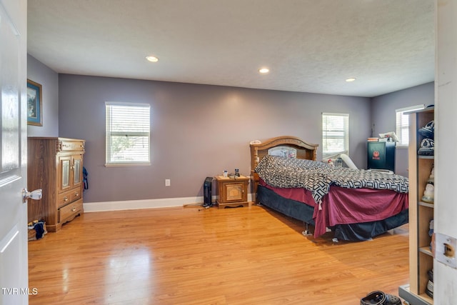 bedroom featuring multiple windows and hardwood / wood-style floors