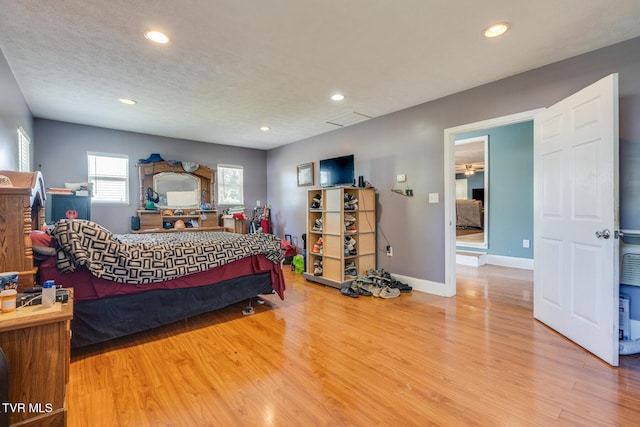 bedroom featuring wood-type flooring and a textured ceiling