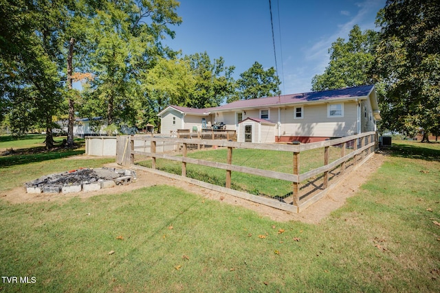 view of yard featuring a shed and a fire pit