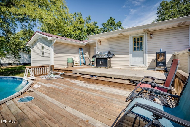 wooden deck featuring a grill