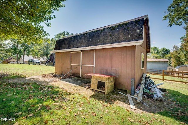 view of outbuilding featuring a lawn