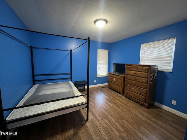 bedroom with dark wood-type flooring