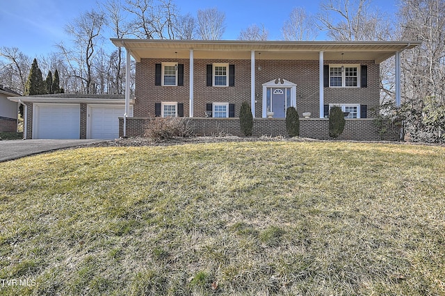 split foyer home with a garage and a front lawn