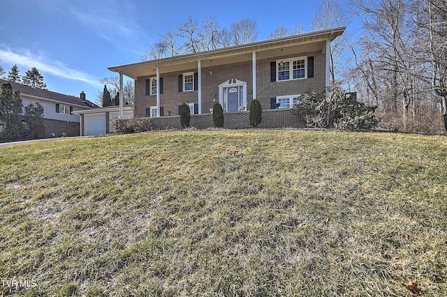 split foyer home with a garage and a front yard