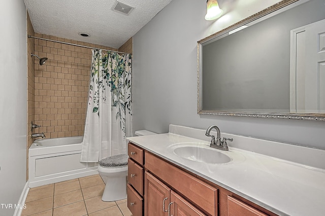 full bathroom with vanity, shower / tub combo, toilet, tile patterned floors, and a textured ceiling