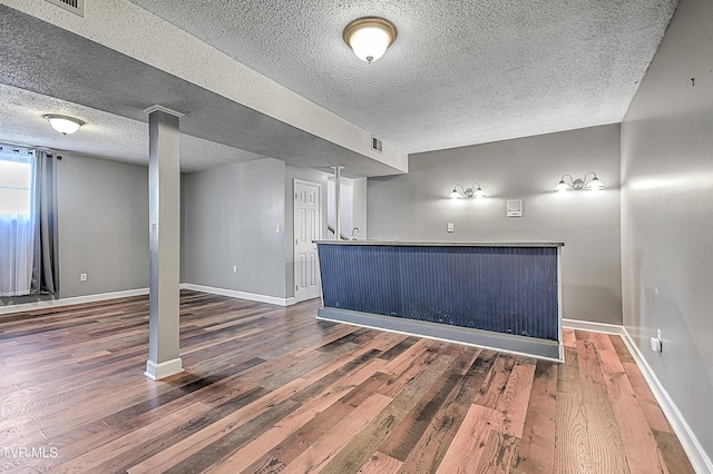 interior space with dark hardwood / wood-style floors and a textured ceiling