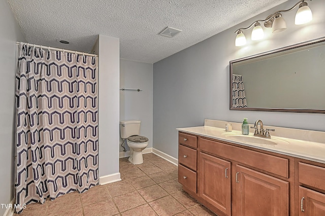 bathroom featuring vanity, toilet, tile patterned floors, a textured ceiling, and a shower with curtain