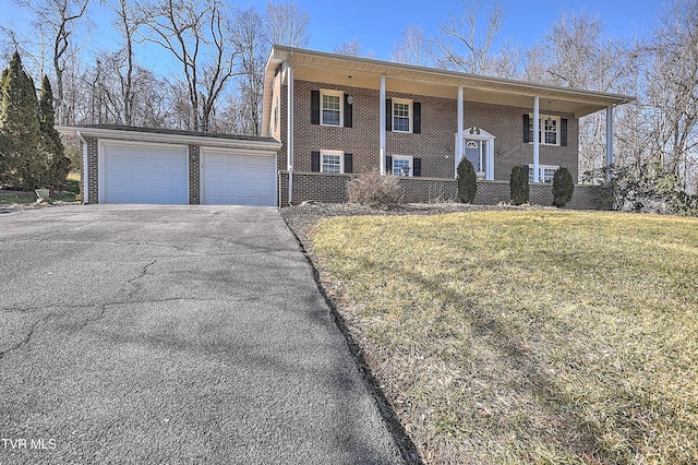 bi-level home with a garage and a front yard