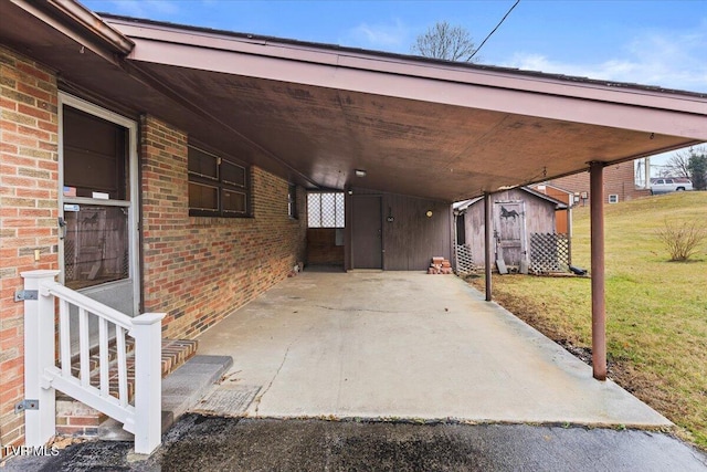 view of patio with a carport and a storage unit