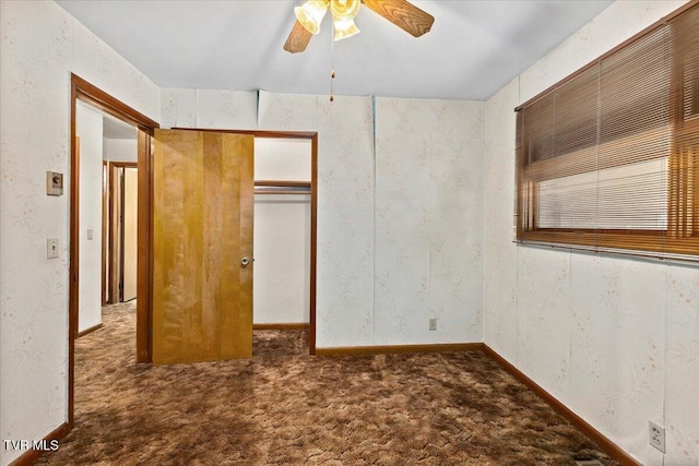 unfurnished bedroom with ceiling fan, a closet, and dark colored carpet