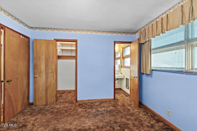 unfurnished bedroom with multiple windows, carpet floors, and a closet