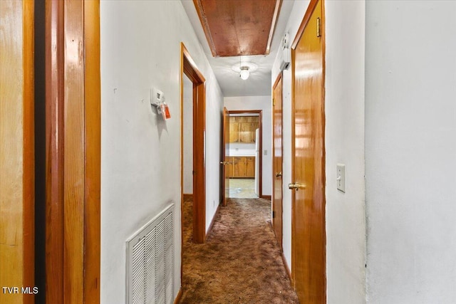 corridor with dark carpet