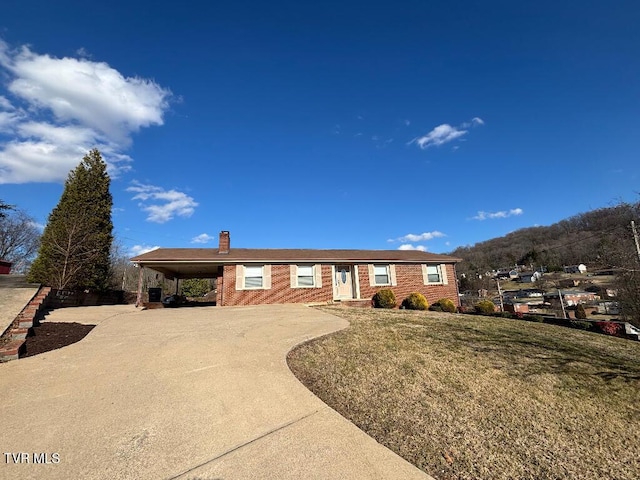 single story home featuring a carport and a front yard