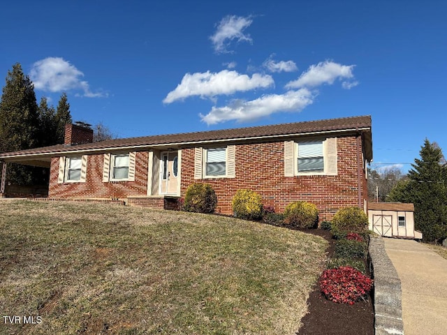 single story home featuring a storage unit and a front lawn