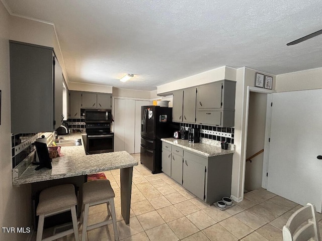 kitchen featuring sink, gray cabinetry, electric range, black refrigerator with ice dispenser, and kitchen peninsula