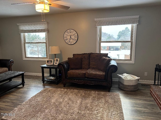 living room with plenty of natural light, dark hardwood / wood-style floors, and ceiling fan