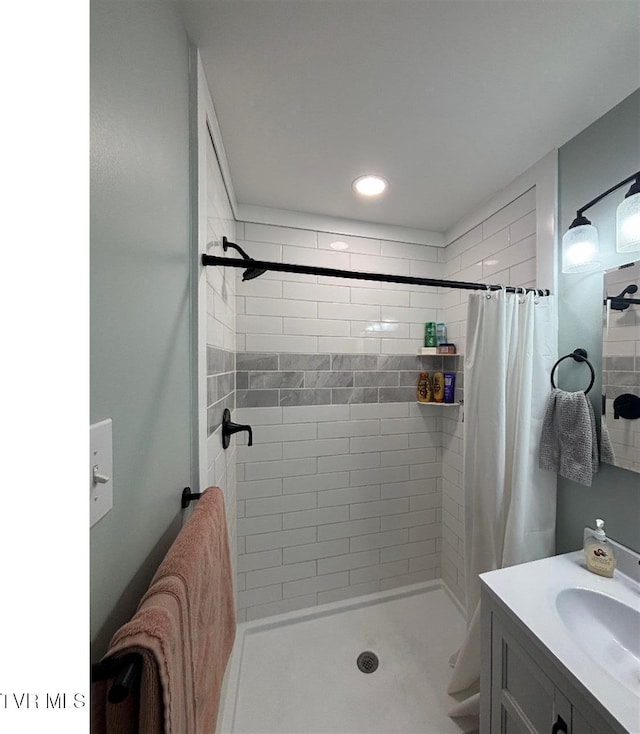 bathroom featuring vanity and curtained shower