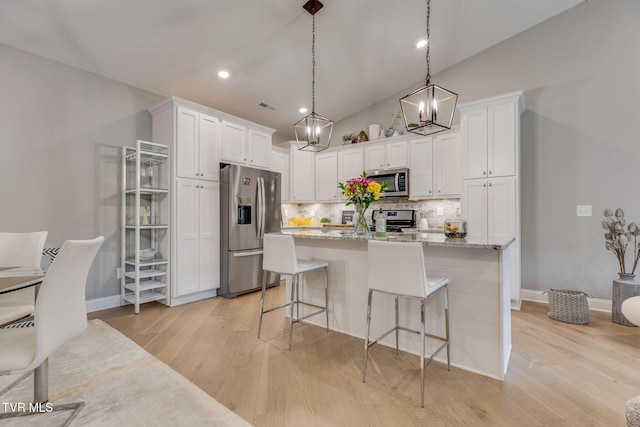 262 Harps Ln, Gray, TN 37615 - kitchen with stainless steel appliances, backsplash, white cabinets, light wood-style flooring, and vaulted ceiling