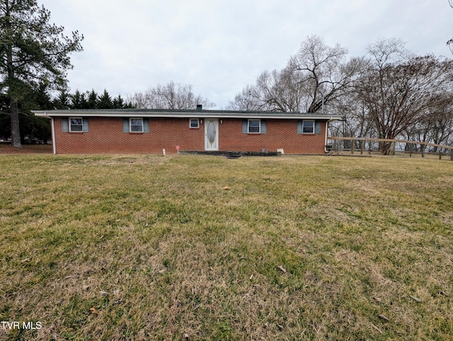 rear view of property with a yard