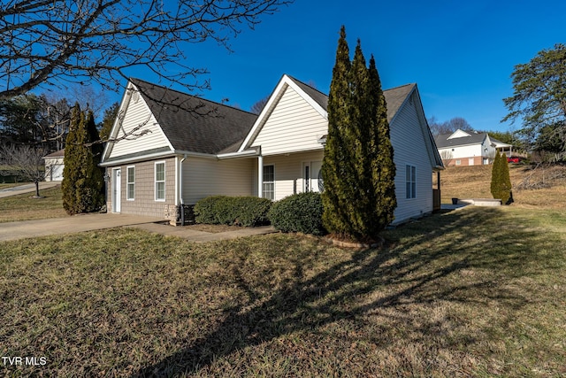 view of side of property with a lawn