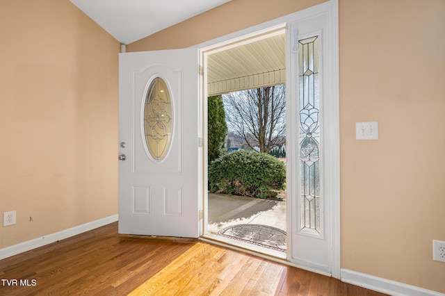 entryway featuring hardwood / wood-style flooring and lofted ceiling