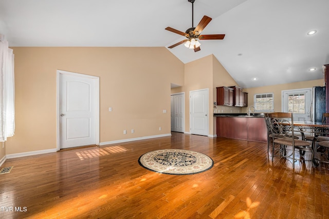 interior space featuring ceiling fan, high vaulted ceiling, sink, and dark hardwood / wood-style flooring