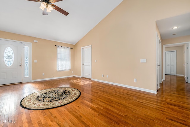 entrance foyer with hardwood / wood-style flooring, ceiling fan, and high vaulted ceiling