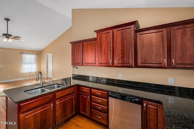 kitchen featuring dark stone counters, dishwasher, sink, and kitchen peninsula