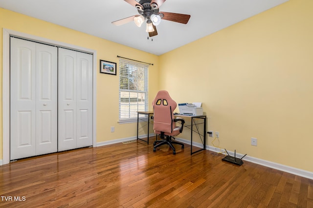 office with wood-type flooring and ceiling fan