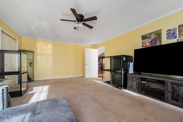 living room with ornamental molding, light carpet, and ceiling fan