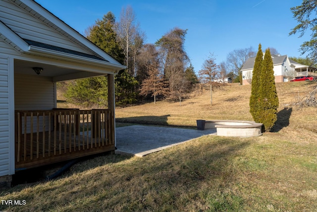 view of yard featuring a wooden deck and a patio area