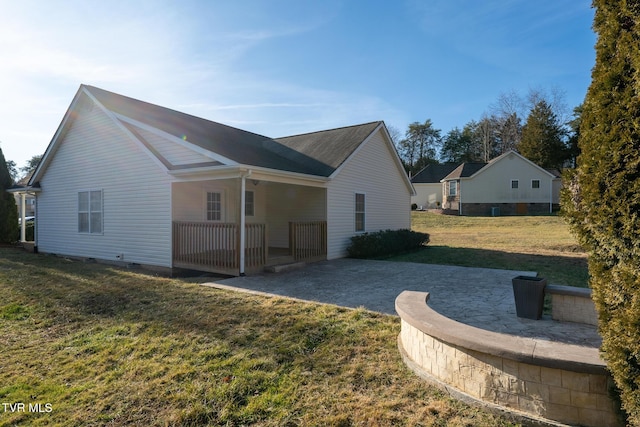 exterior space featuring a porch, a patio, and a lawn