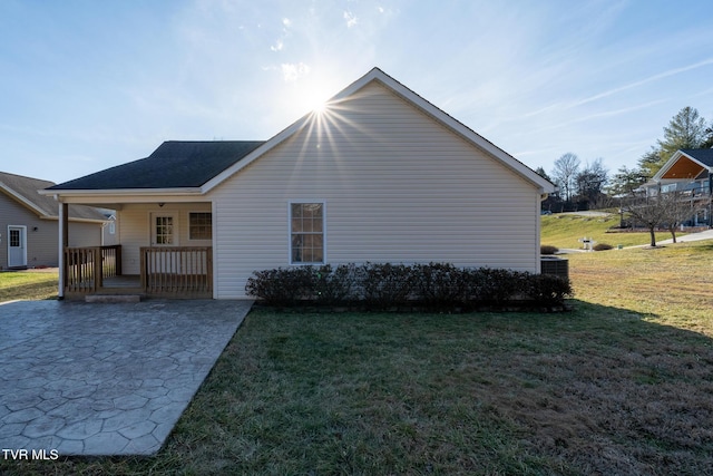 view of property exterior featuring a lawn and a porch