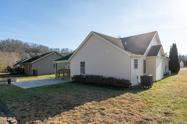 view of home's exterior featuring central AC, a patio area, and a lawn