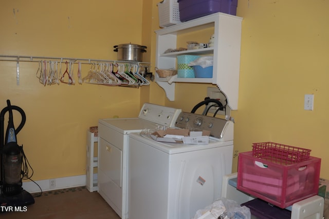 clothes washing area with separate washer and dryer