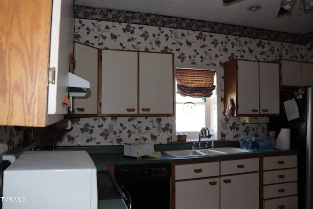 kitchen featuring sink, white cabinetry, ventilation hood, stainless steel refrigerator, and black dishwasher