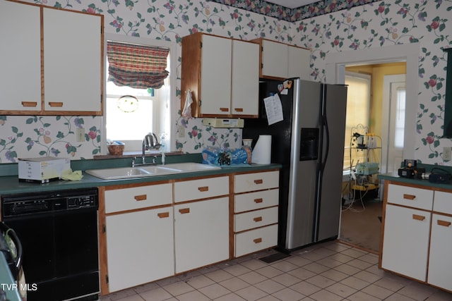 kitchen with light tile patterned flooring, sink, white cabinetry, stainless steel fridge with ice dispenser, and black dishwasher