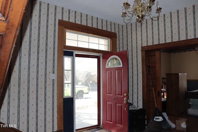 foyer with an inviting chandelier