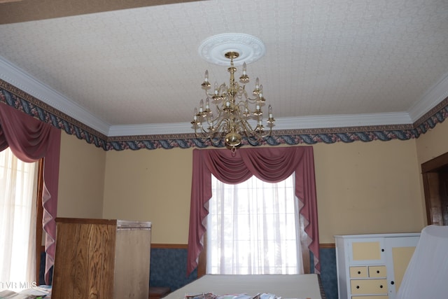 interior space with ornamental molding and a chandelier