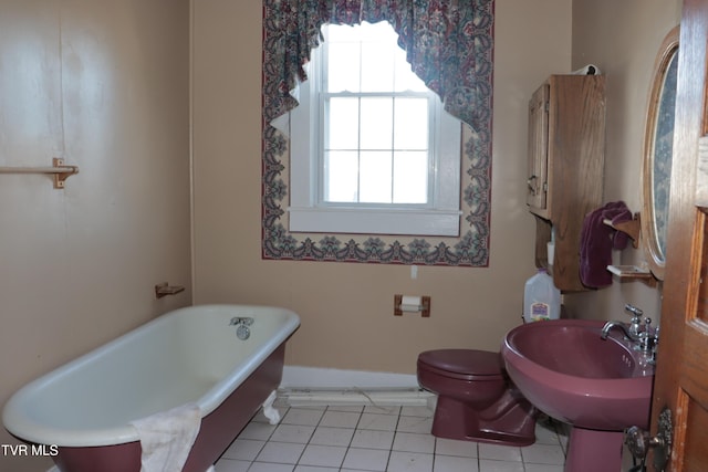 bathroom featuring toilet, tile patterned flooring, sink, and a tub