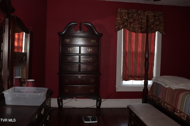 bedroom with dark hardwood / wood-style floors