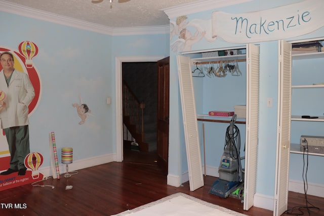 bedroom featuring crown molding, a closet, dark hardwood / wood-style flooring, and a textured ceiling