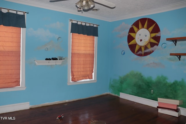 spare room featuring hardwood / wood-style flooring, crown molding, and ceiling fan