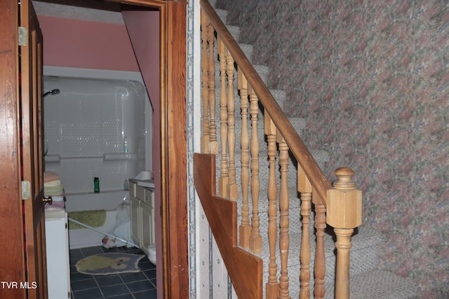 staircase featuring tile patterned flooring