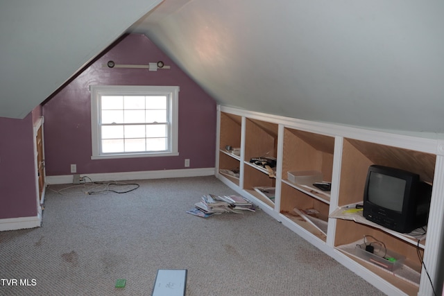 bonus room featuring lofted ceiling and carpet