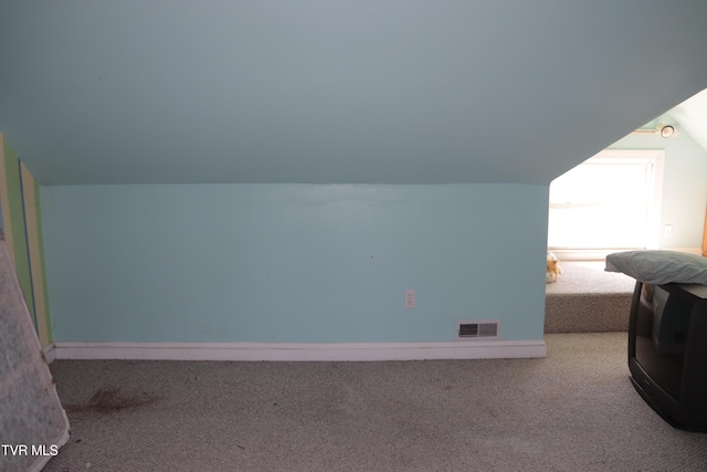 bonus room featuring carpet flooring and vaulted ceiling