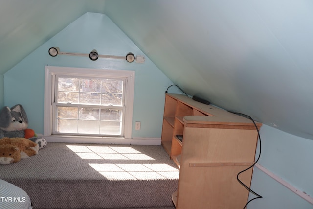 additional living space featuring light carpet and vaulted ceiling